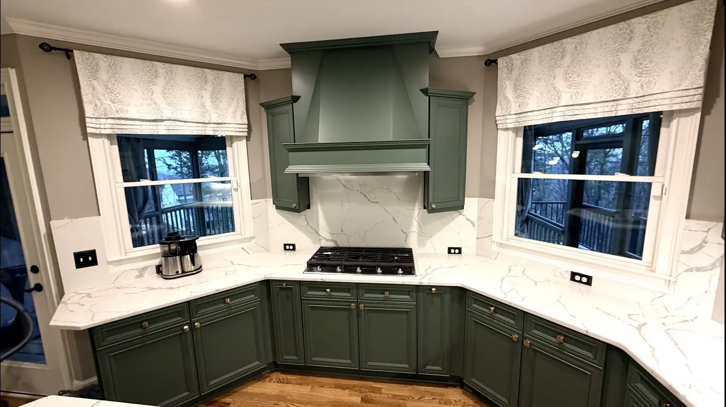 Cabinet Painting Guys client kitchen with green painted cabinets in a wide open layout