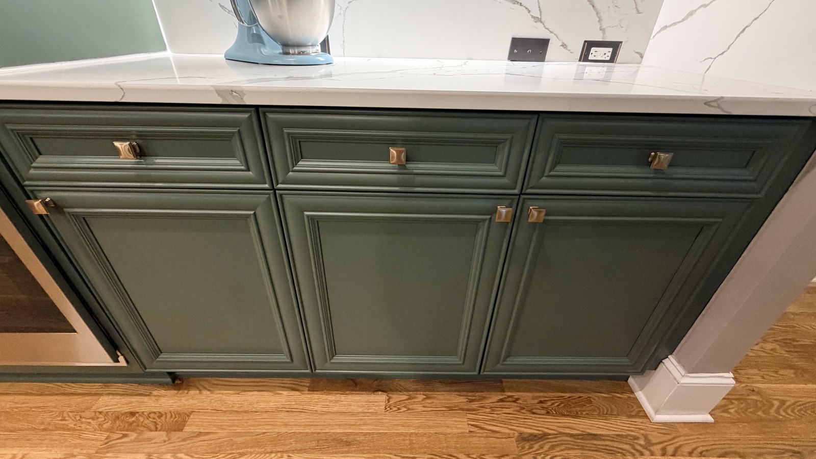 Close detail of painted cabinet drawers and brass hardware, Rosemary green, a Cabinet Painting Guys client job