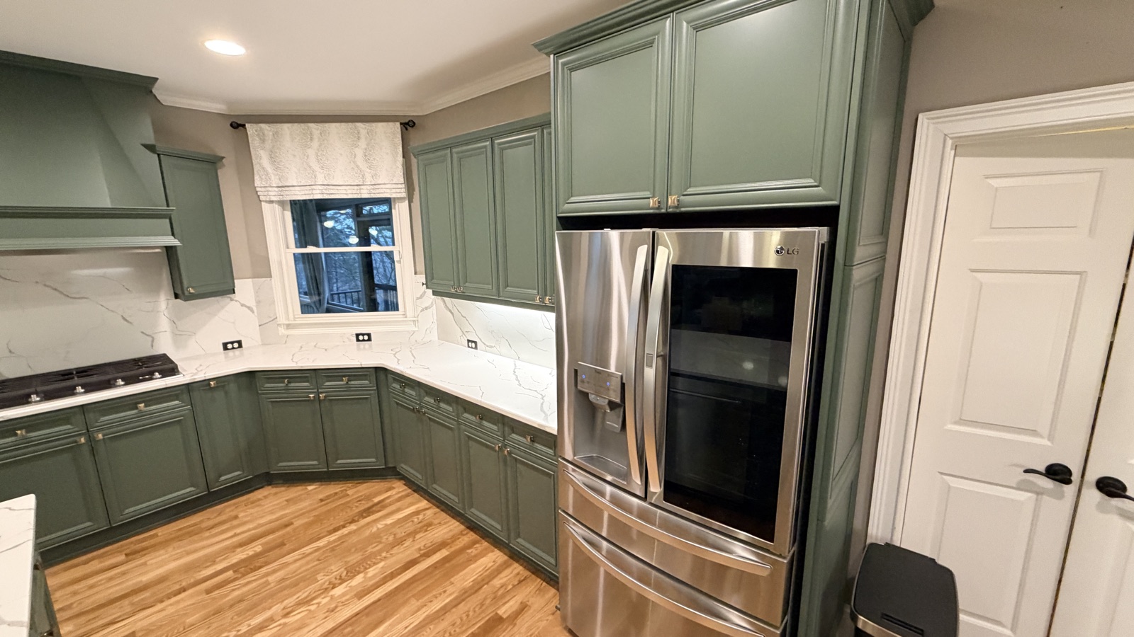 Real finished kitchen with Rosemary green cabinets, a Cabinet Painting Guys client job