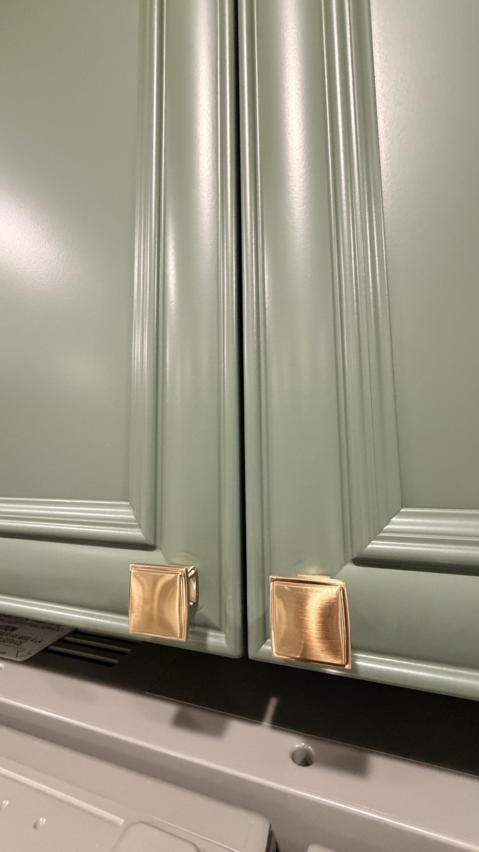 Close-up of new cabinet hardware on a recently painted kitchen cabinet
