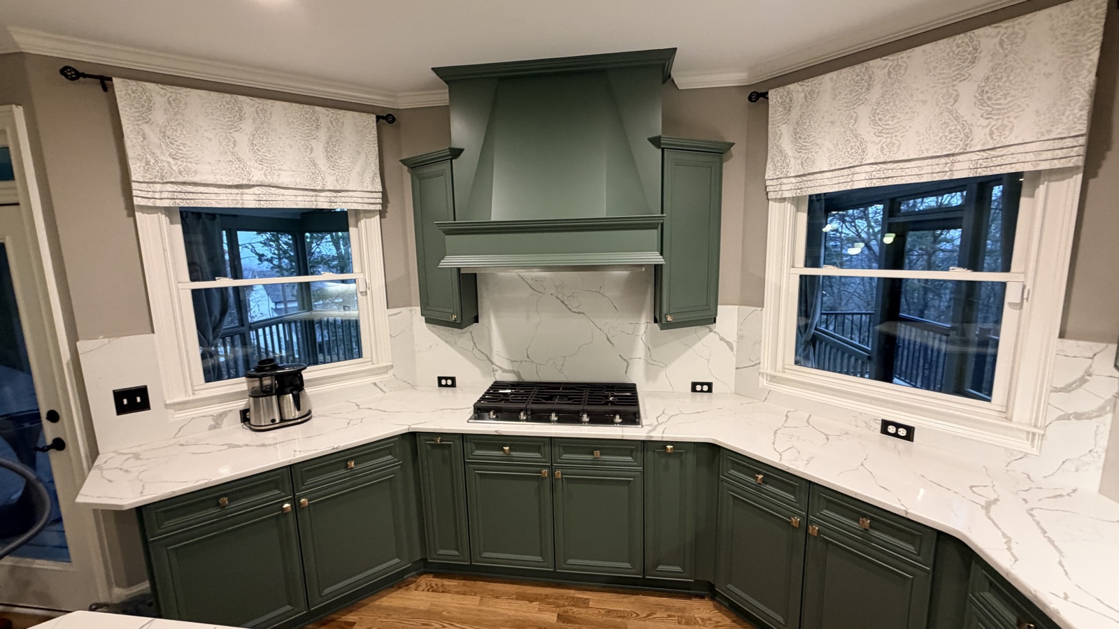 Real painted kitchen with Rosemary green cabinets and a custom hood, a Cabinet Painting Guys client job