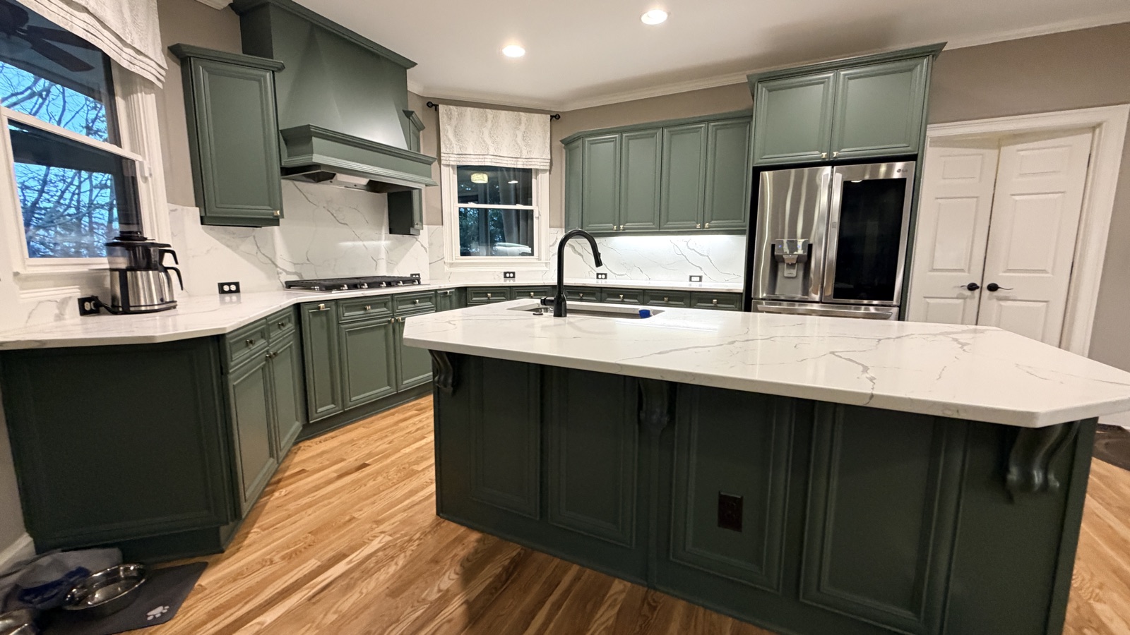 Real finished kitchen island with Rosemary green cabinets, a Cabinet Painting Guys client job